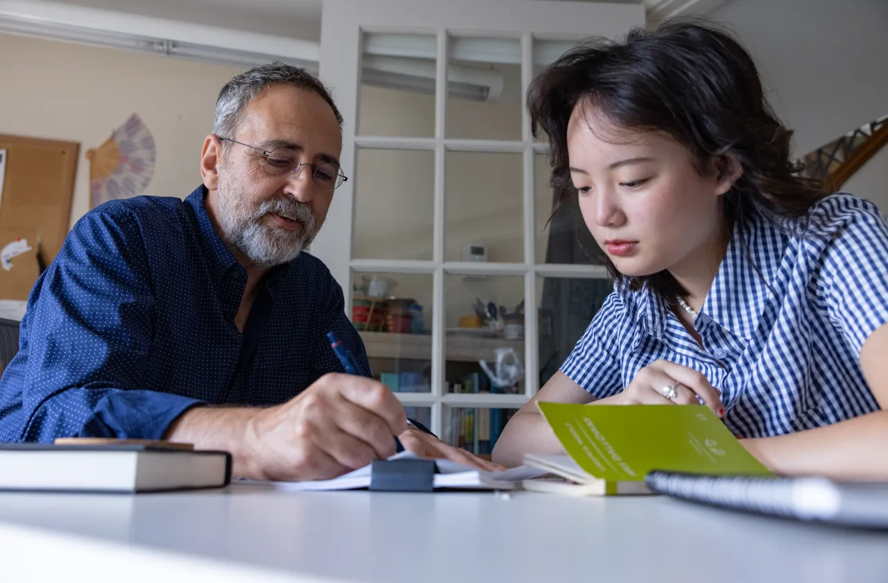A student and professor talk in the Jacobson Center