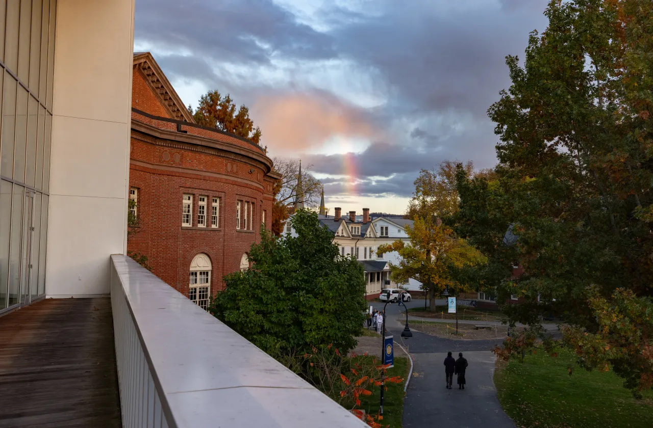 A rainbow peeks through the clouds over Haven-Wesley house