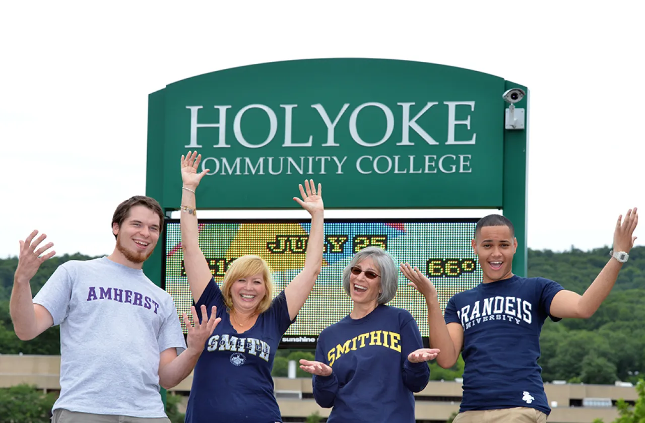 Four students pose in front of Holyoke Community College sign