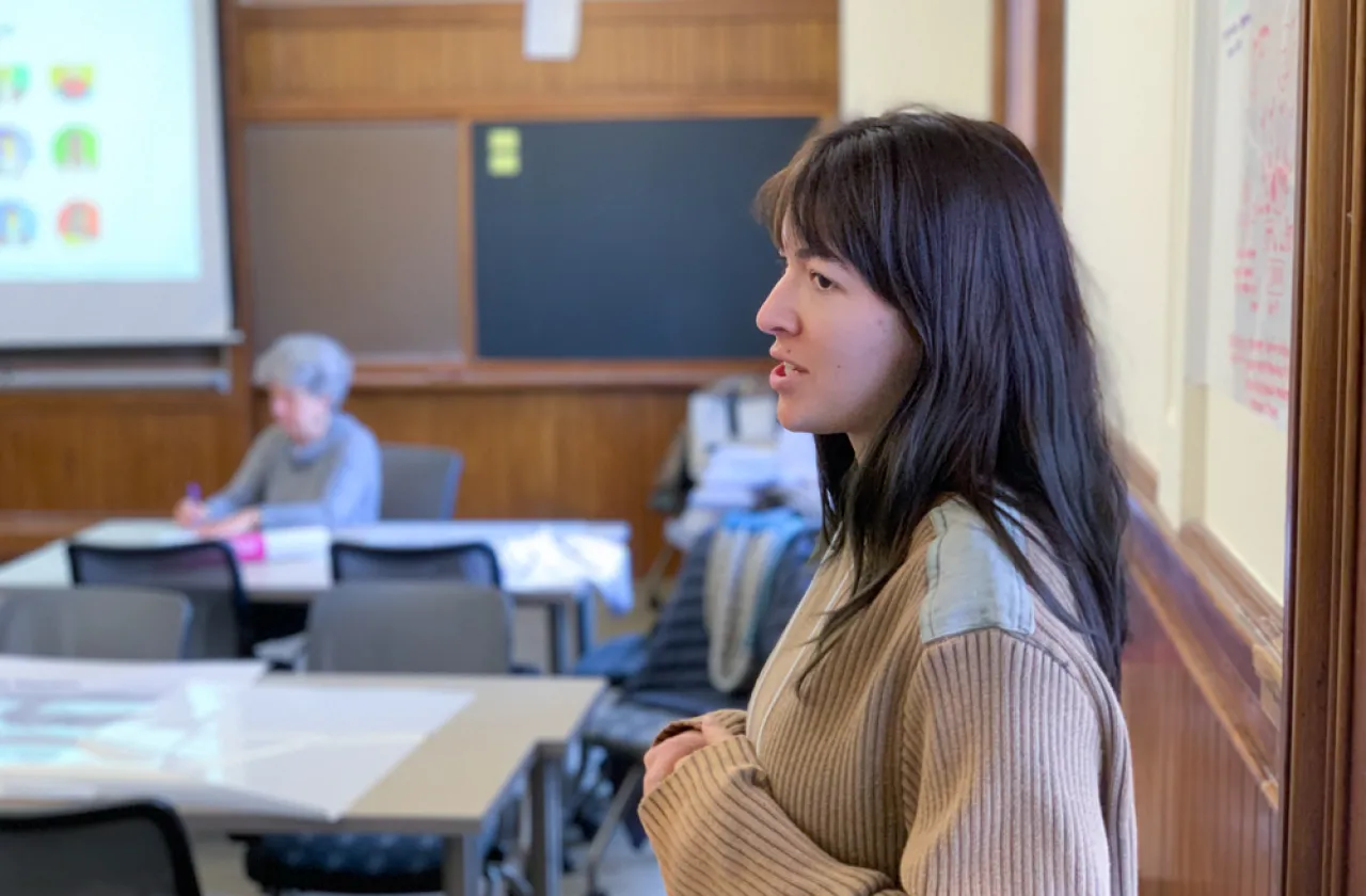 Luca Jacodine standing at a white board speaking to a classroom