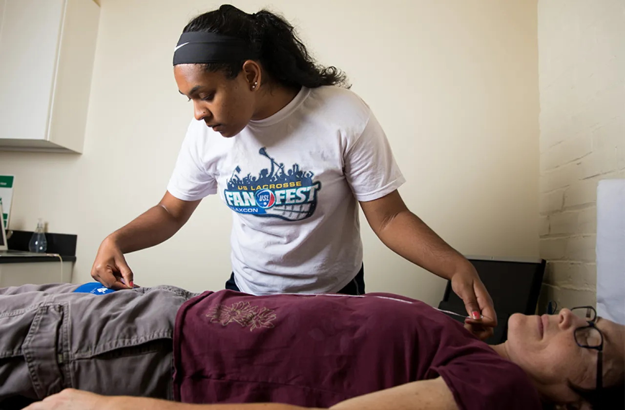 Abigail Edwards '20 demonstrates a pulse wave velocity test on her summer research adviser