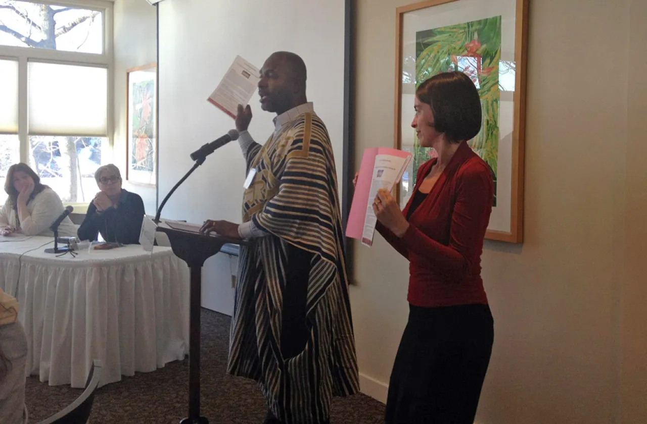 Alfred Babo at a podium speaking to attendees
