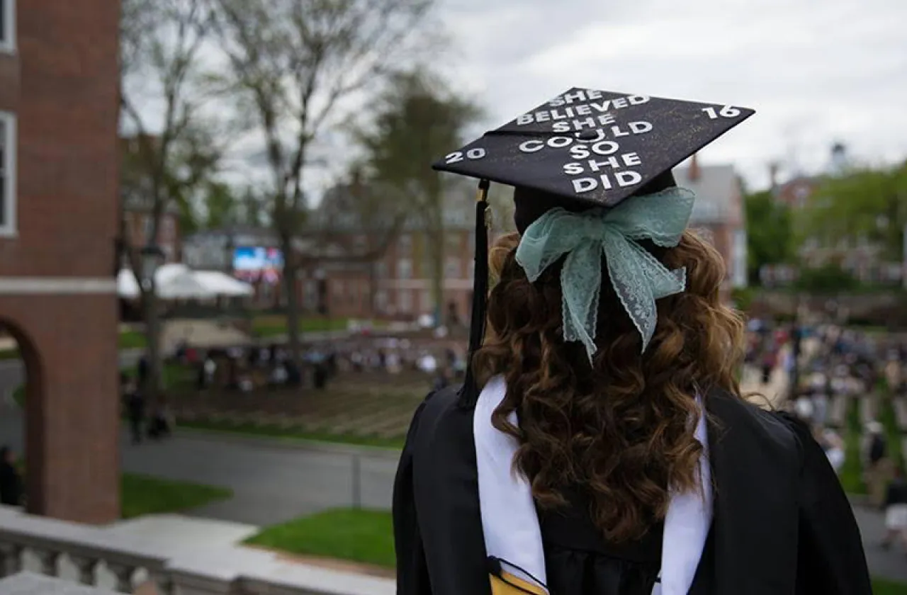 Student in commencement cap reading “She believed she could so she did”