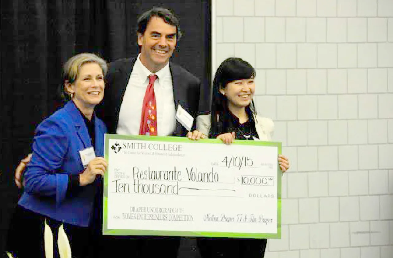Melissa Draper '77 and her husband, Tim, giving first place award to Wellesley student Mojia Shen at last year's Draper Competition at Smith. Smithies hope to take the top prize this year.