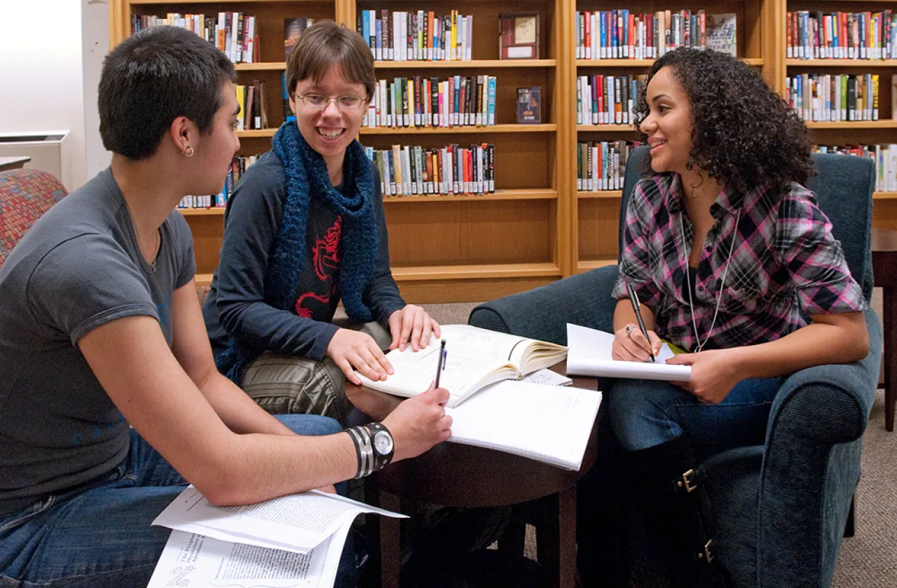 Three students work together in Neilson Library