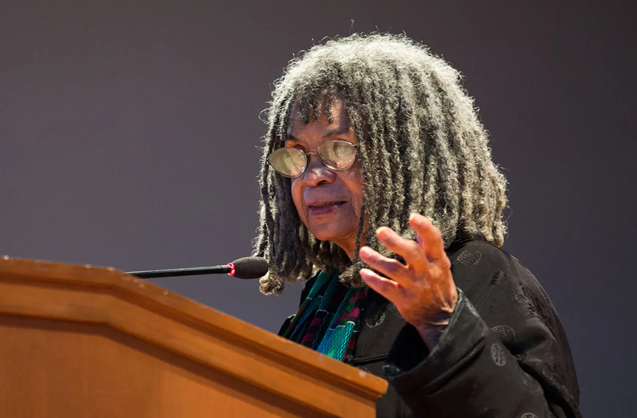 Sonia Sanchez speaking at a podium