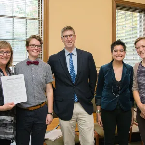 President Kathleen McCartney displays the college's Real Food Challenge commitment