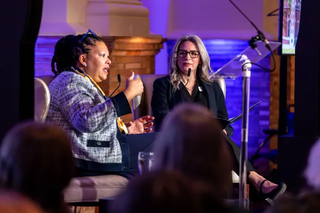 President Sarah Willie-LeBreton on stage with Amanda Rivera Lopez during a Q&A session with alums in Boston.