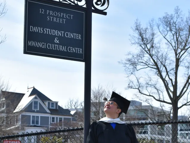 Marcela Rodrigues next to the Mwangi Cultural Center sign