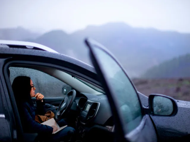 Noelle Crombie in a car on Highway 20