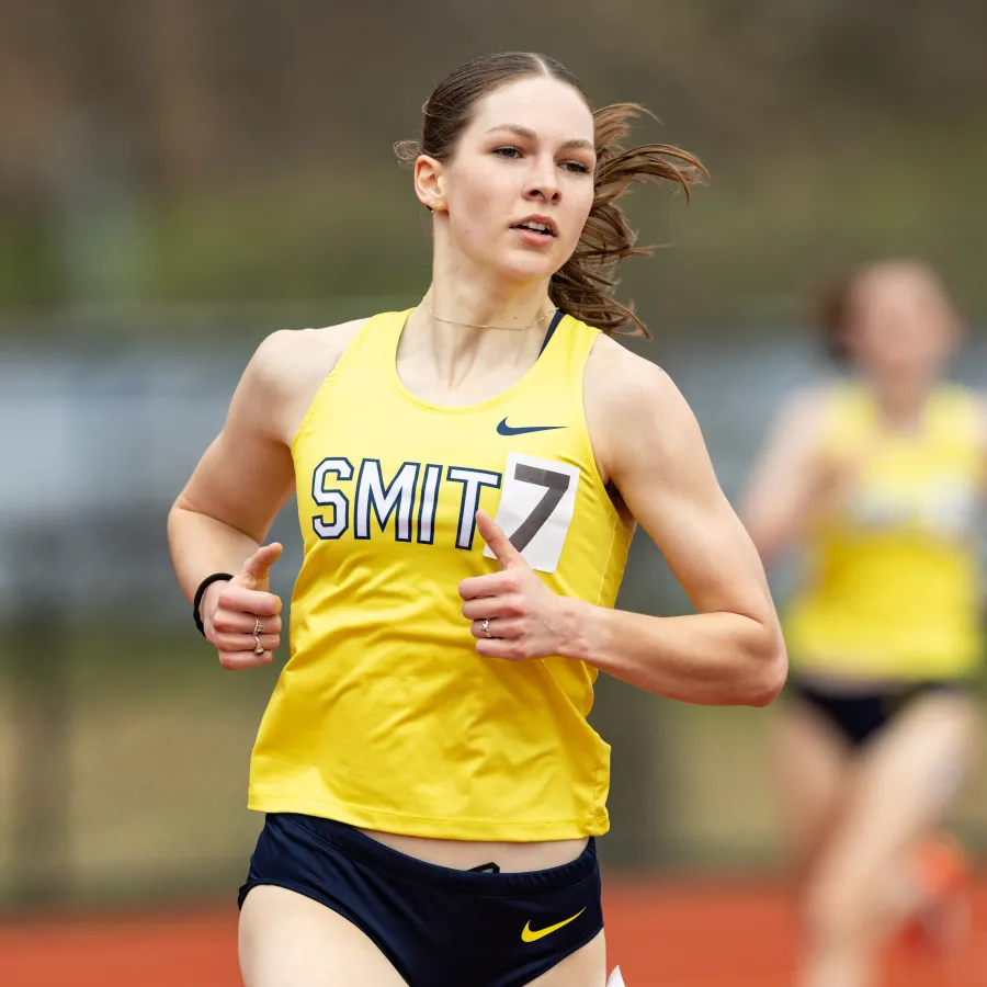 Smith senior Lyda Martin runs on the track in her gold and blue Smith gear