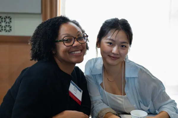 Two women smile during an alum summit event at Smith College in 2026.