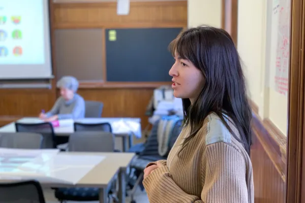 Luca Jacodine standing at a white board speaking to a classroom