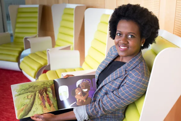 Priscilla Semphere holding her book Ekari