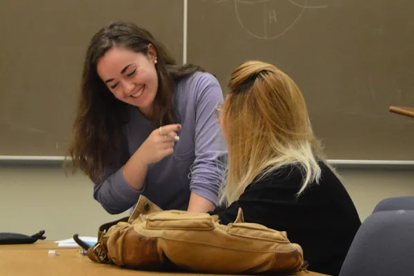 Samantha Comeau '18 helps Dayana Meza '21 solve an equation