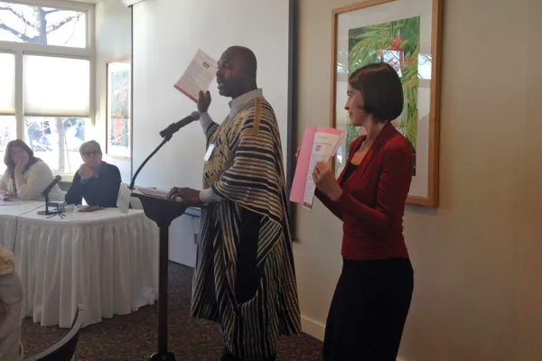 Alfred Babo at a podium speaking to attendees