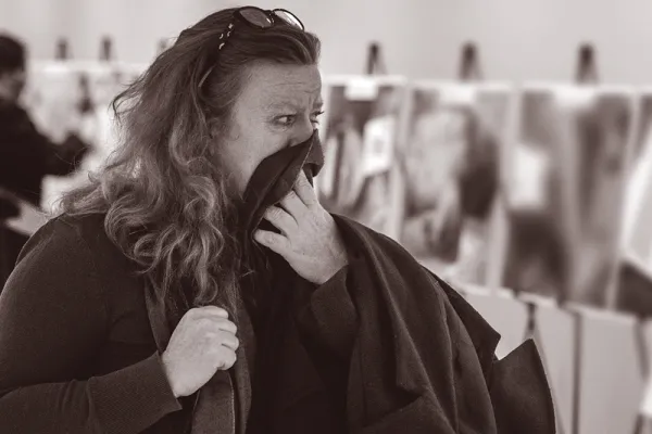 A woman viewing the exhibition of Caesar photographs