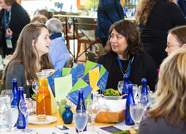 Alumnae volunteers sitting around a table
