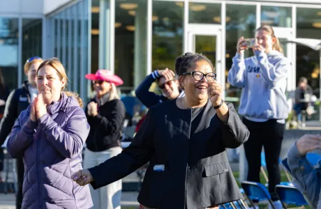 President Sarah dancing with Smith community members