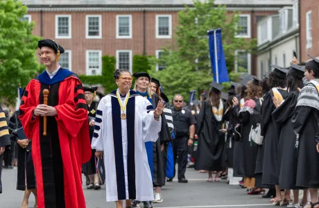 President Sarah waving to graduates in the Quad during Commencement 2025.