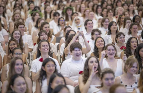 A group of seniors laugh in the crowd on Ivy Day