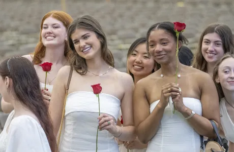 Seniors smile and hold roses on Ivy Day