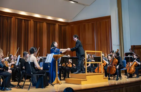 President Sarah onstage with the Smith orchestra during Smith Arts Day 2025.