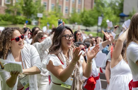 An alum smiles during the alumnae parade