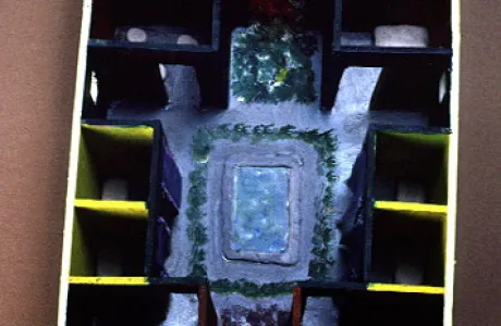 Overhead view of a model of an ancient Roman house. Central courtyard with a blue pool, surrounded by small rooms and greenery.