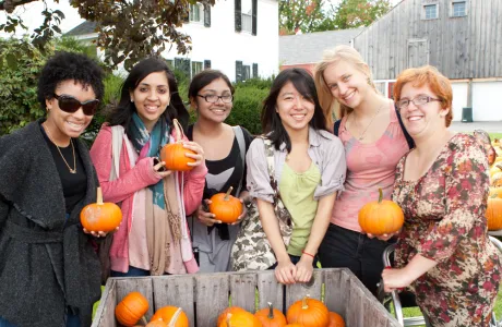 Smith students in 2011 holding mini pumpkins on Mountain Day