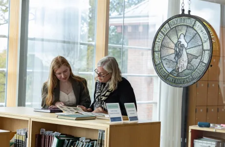 A Smithie and a family member look at materials in the archives during Family Weekend.