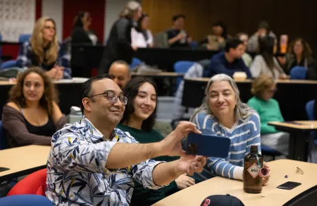 A family takes a selfie during Family Weekend