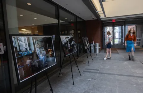 A student looks at a photography exhibit