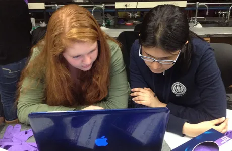 Two students reviewing data