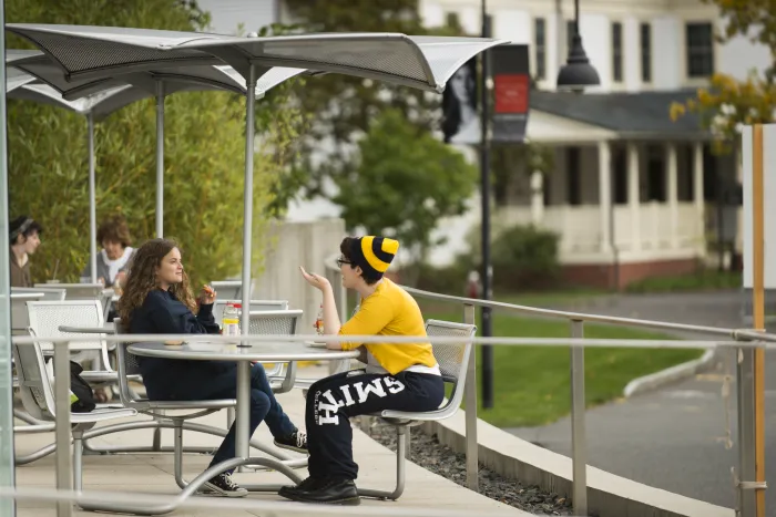 Two students sitting outside of the Campus Center.