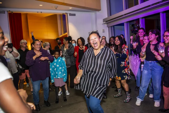 Sarah Willie-LeBreton smiling and dancing at a dance party with students.