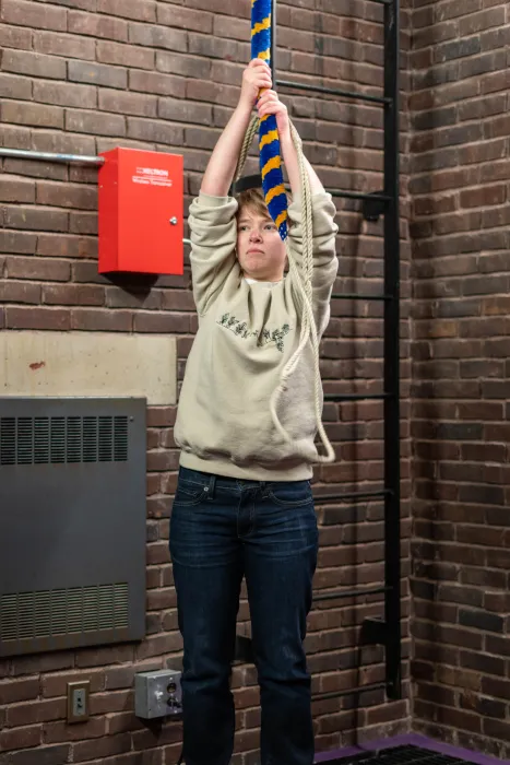 Maisy Hoffman ’25 reaches high for a rope in Mendenhall Bell Tower