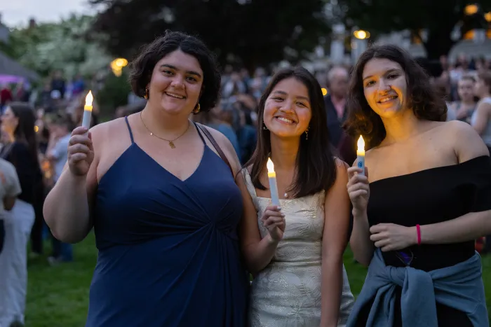 Students holding candles during illumination night