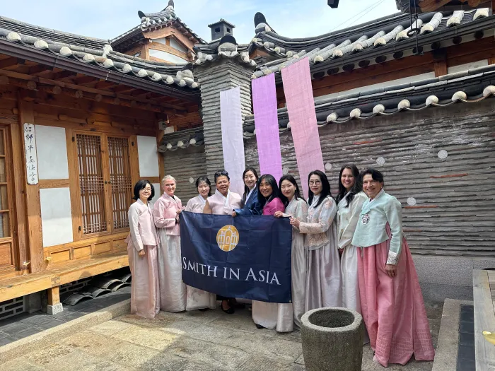 President Sarah Willie-LeBreton and Smith College alums hold a Smith in Asia banner.