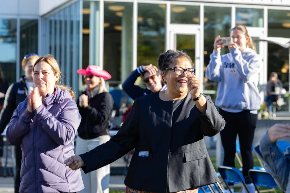 President Sarah dancing with Smith community members