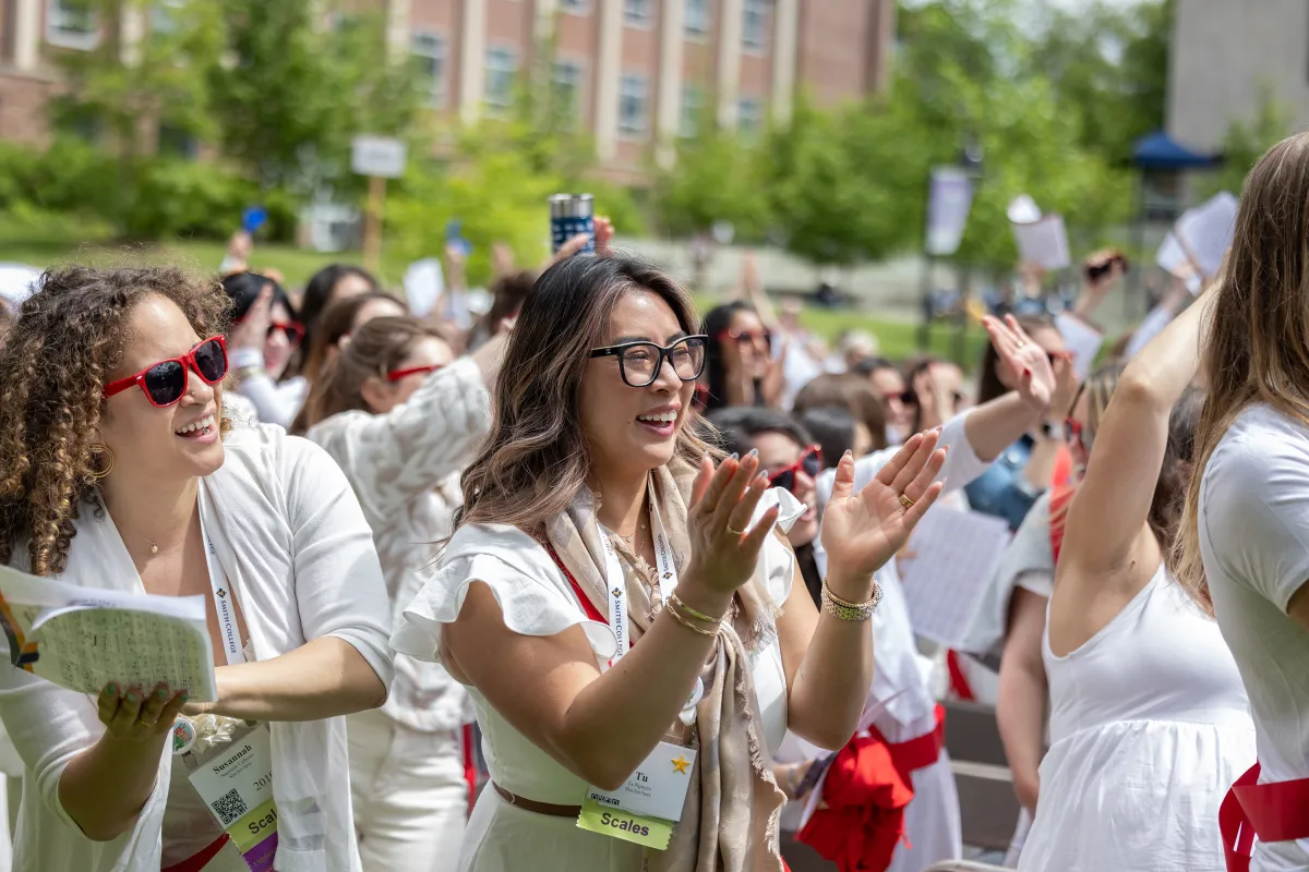 An alum smiles during the alumnae parade