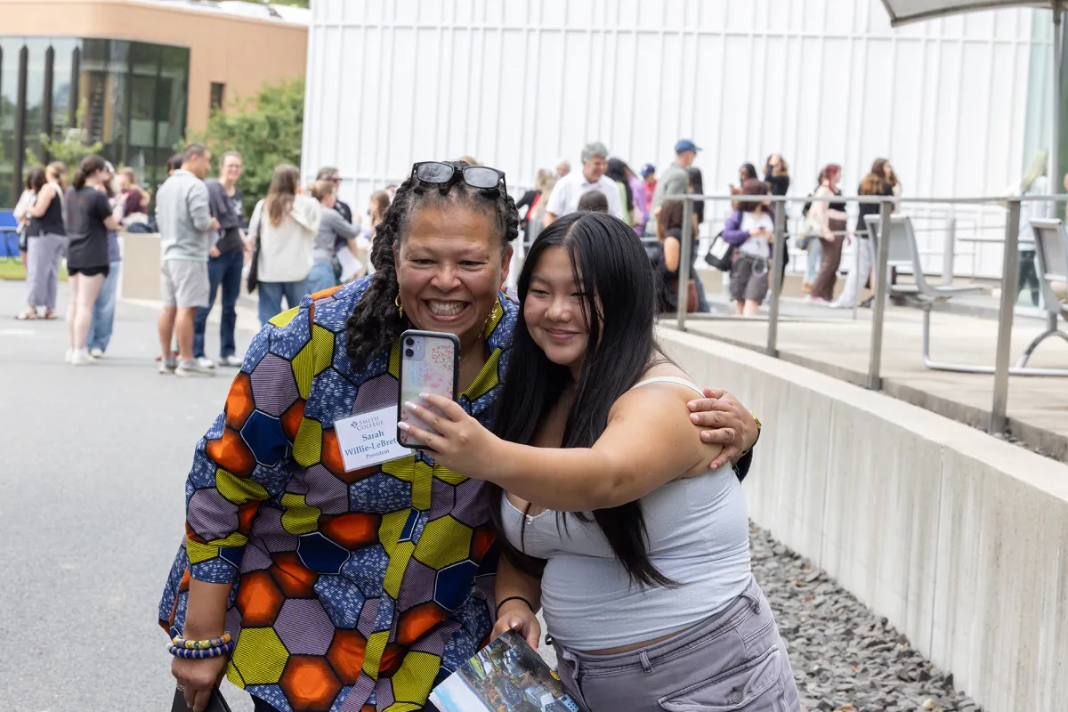President Sarah Willie-LeBreton taking a selfie with a new student during Central Check-In