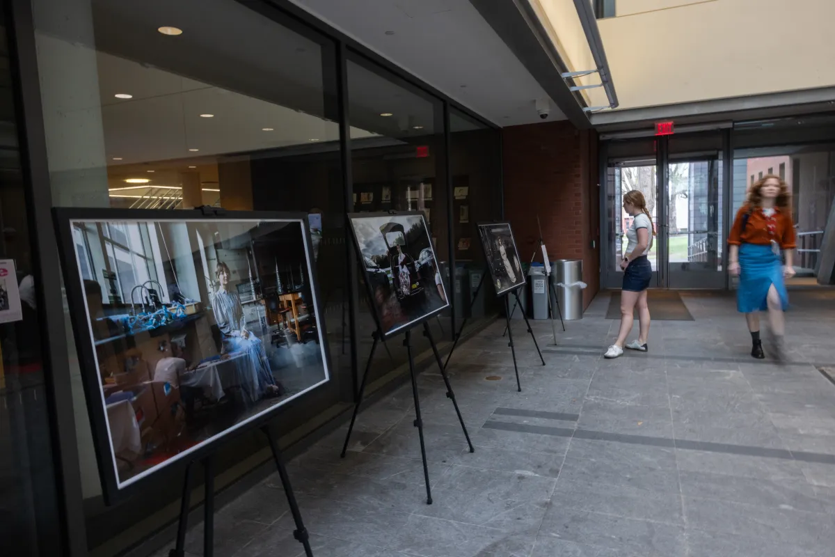 A student looks at a photography exhibit