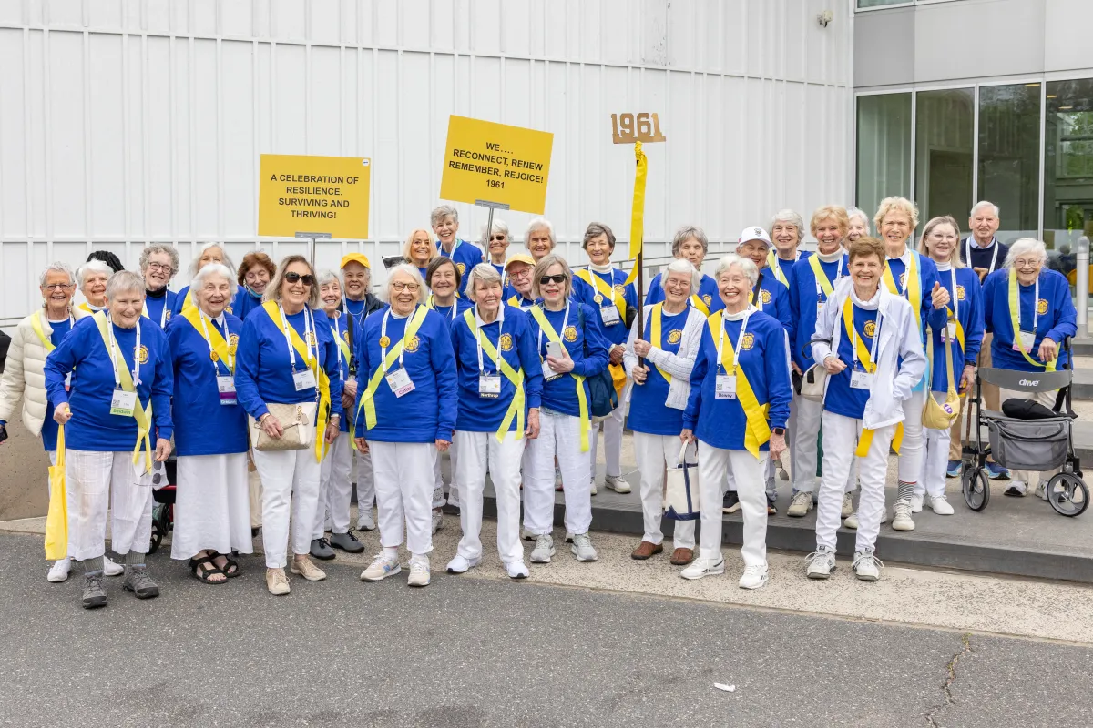 Members of the class of 1961 in matching blue sweaters before the alumnae parade