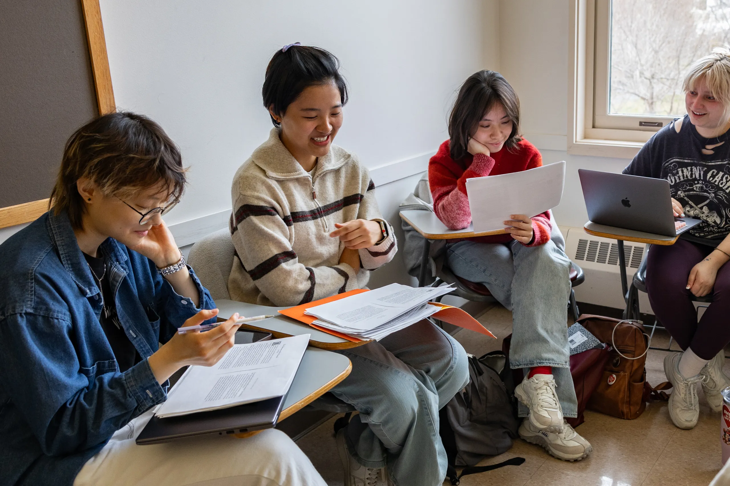 Students sit and discuss a reading together