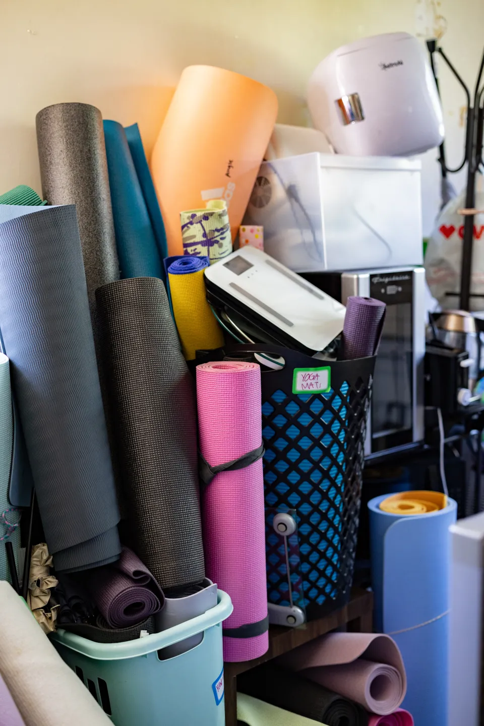 Piles of colorful yoga mats at SmithCycle in Scales House basement