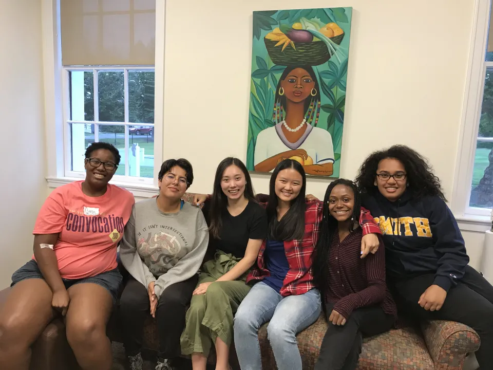 Members of the various Unity organizations sit on a couch posing for a photo