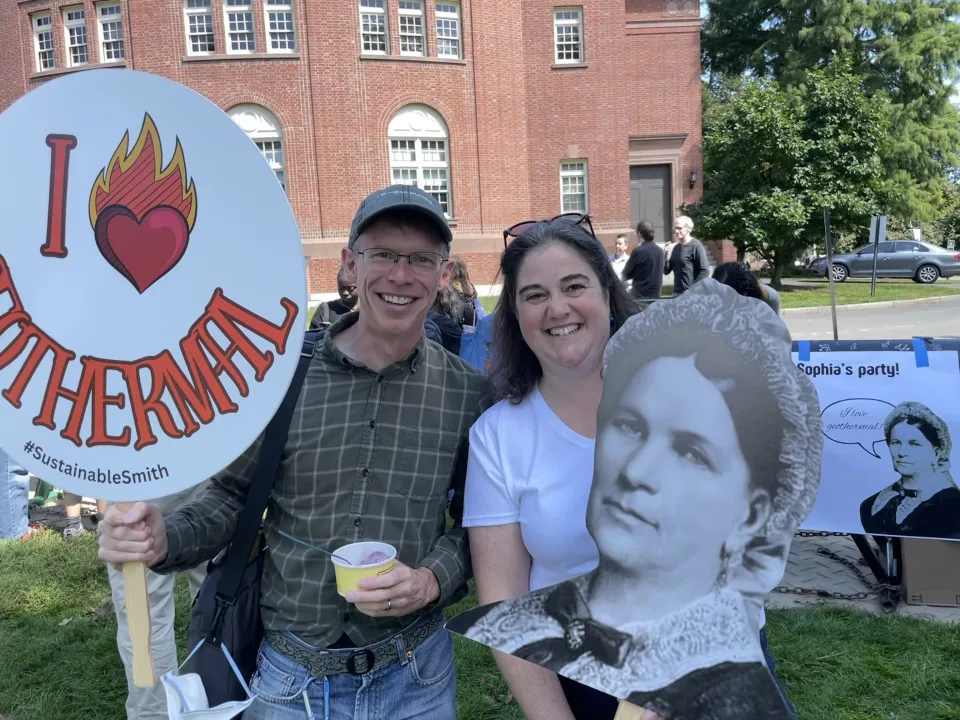 Susan Sayre holding a giant photo of Sophia Smith during the college's 150th birthday party.