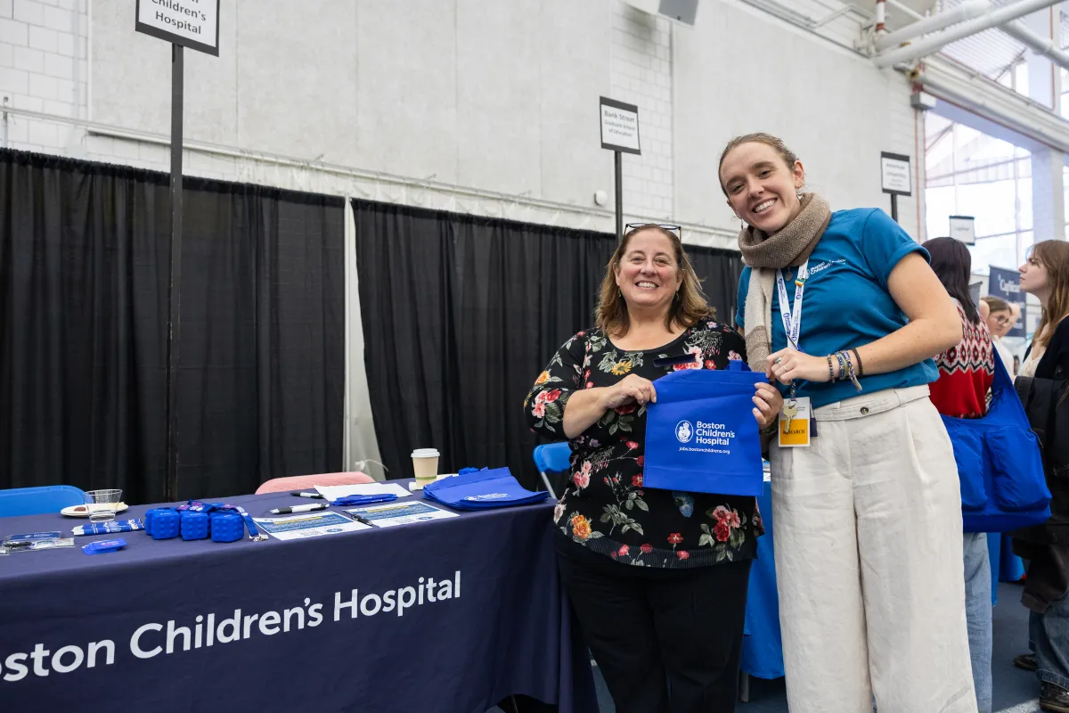Emma Haims '26 and Elicia Estrella '90 representing the Boston Children's Hospital table at the Job & Internship Fair.