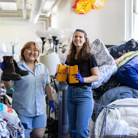 Jena Kim and Molly Neu sorting through items at SmithCycle in Scales House basement